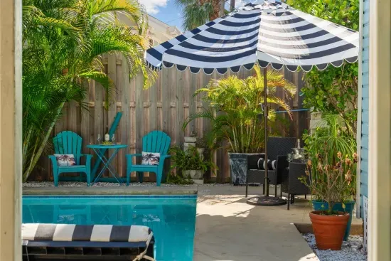 Take a dip in the heated pool or relax poolside with a cocktail in hand. The striped umbrellas and loungers add a touch of resort-style luxury.