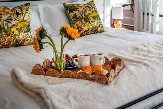 Thoughtful touches like a breakfast tray and warm lighting create a relaxing start to the day.