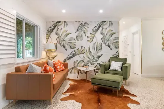 Living Room Retreat: Vibrant decor, stylish seating, and natural light await your relaxation!