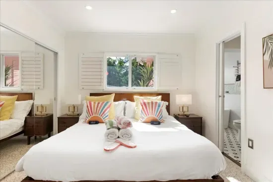 Master Bedroom: Bright and inviting retreat with stylish decor and en-suite bath access!