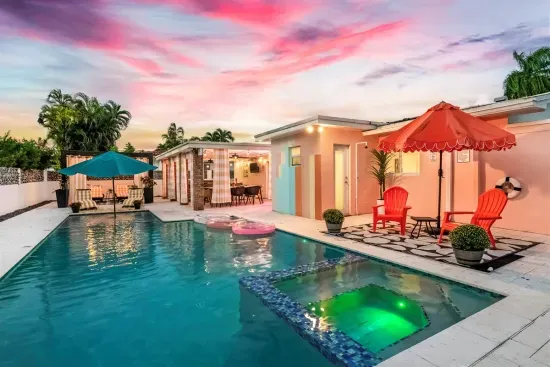 Outdoor Paradise: Enjoy vibrant sunsets by the pool with colorful seating and refreshing vibes!