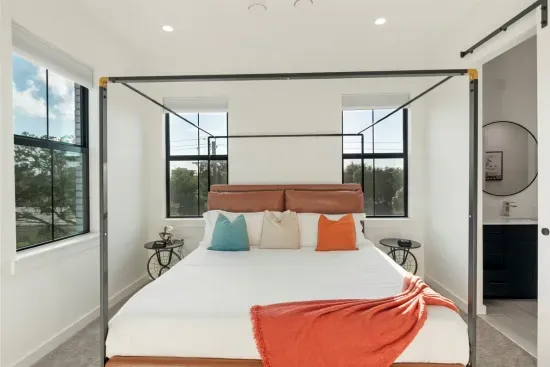 Master Bedroom: Enjoy bright views from this elegant space with a king bed and stylish decor! 