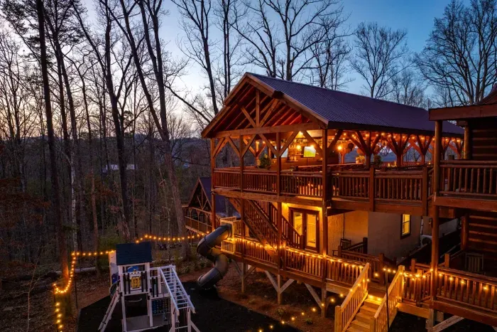 A heated indoor pool, hot tub, play ground, climbing walls, sports bar, oversized slide, and eating and lounging for 20…you and your guests will never want to leave the cabin!