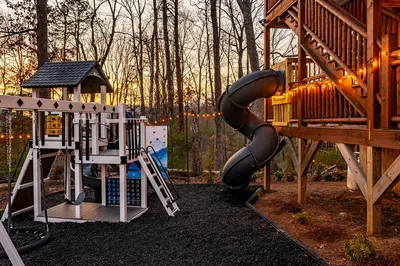 Outdoor play structure with two story slide and climbing wall