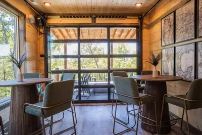 The garage door goes up and down to allow a true indoor/outdoor experience with high top seating for eight. Cocktails or coffee with a view please.