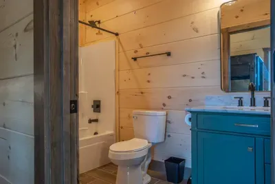 En suite bathroom with tub and vanity.