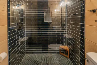 Spacious en suite showers with dual shower heads.