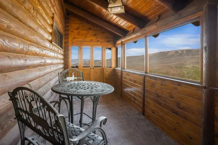 Enjoy a cup of coffee in the enclosed deck located near the hot tub.