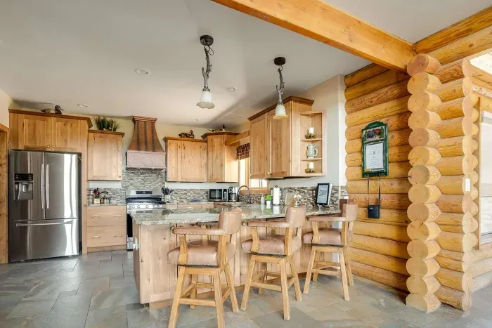 Kitchen bar with 3 luxury leather chairs.