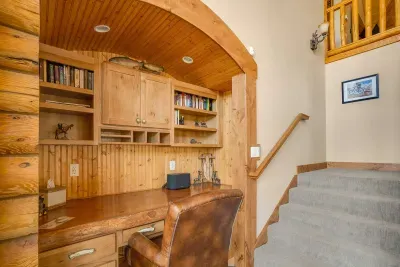 Main floor office area with comfortable leather office chair and wide desk.