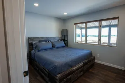 This King bedroom is equipped with a desk and 4K TV.