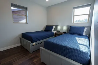 This bedroom features two brand new premium twin mattresses.