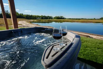 Relax in our hot tub spa with stunning views of Sunset Lake and the surrounding forest.