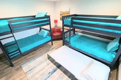 350 lb capacity for each sleeping surface; 
4 twin beds plus a trundle
(DOWNSTAIRS)