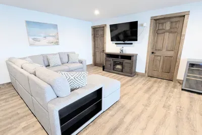 A perfect area for gathering, complete with an electric fireplace and a sleeper sofa. (DOWNSTAIRS)