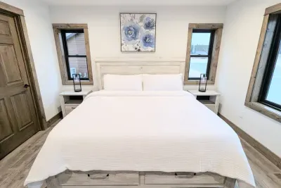 A beautiful king bed in the primary bedroom with adjoining full bathroom.