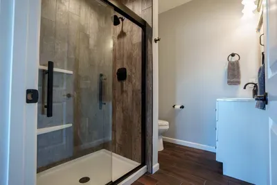 This full bathroom features a step-in tiled shower.