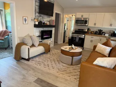 Bright, thoughtfully designed living space with fireplace and fully equipped kitchen.