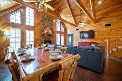 Large open concept living and dining with a view of the loft