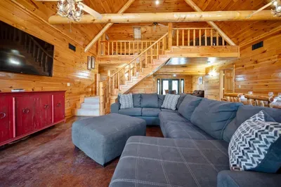 Large open concept living and dining with a view of the loft