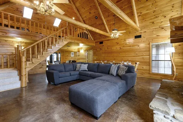 Large open concept living and dining with a view of the loft
