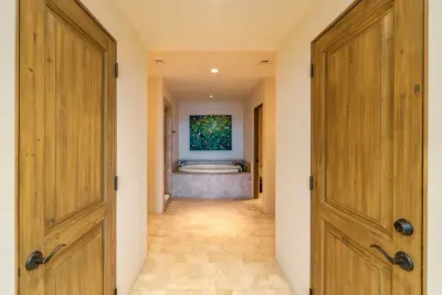 Main bath with dual sinks, shower, toilet, soaking tub