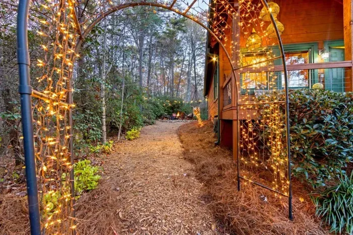Step through the lighted archway — your private entrance into a cozy mountain escape
