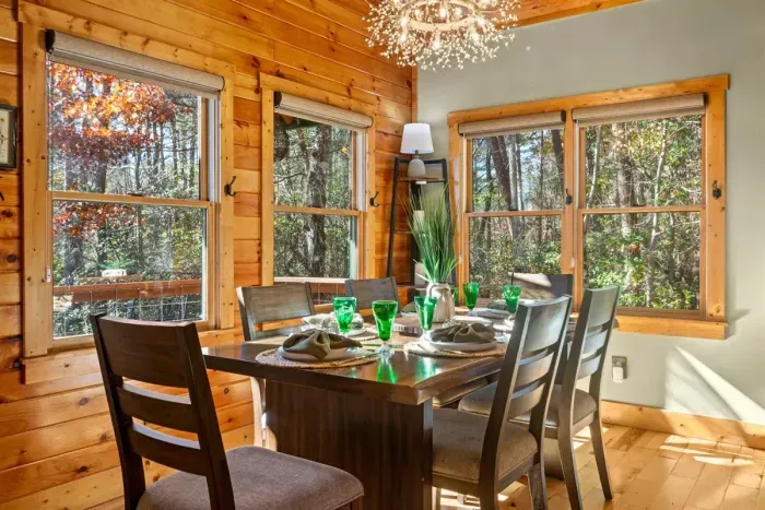 Bright dining nook with forest views — morning coffee here feels dreamy