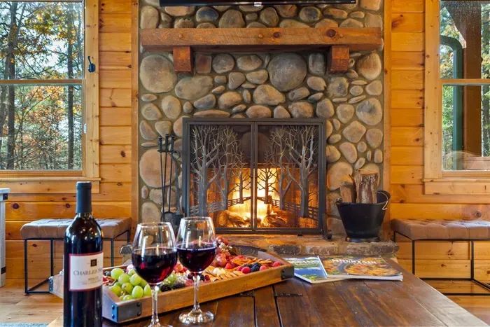 Evenings are better with wine by the fire — pure cabin comfort