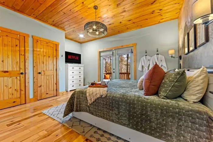 Relax in the king suite with luxury bedding and soft cabin lighting