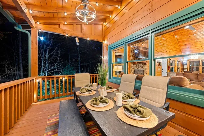 Twilight dinners on the porch — warm string lights create a magical mountain evening