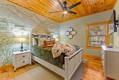 Custom Helen-themed mural bedroom — discover local landmarks hidden within the design as part of the cabin’s scavenger hunt