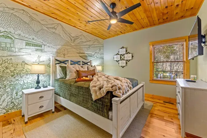 Custom Helen-themed mural bedroom — discover local landmarks hidden within the design as part of the cabin’s scavenger hunt