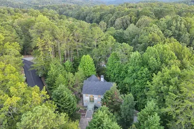 A secluded mountain retreat surrounded by lush greenery and breathtaking views—perfect for a peaceful escape in nature.