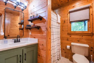 Downstairs bathroom located just off the queen bedroom, with a walk-in shower and private vanity.