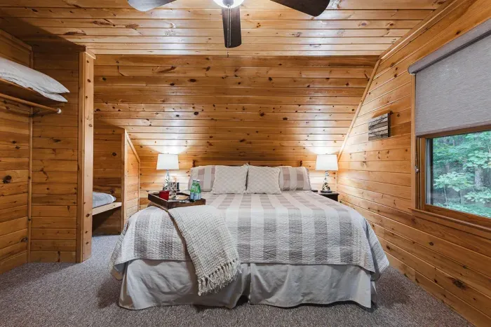A quiet upstairs retreat surrounded by trees — the kind of sleep you only get in the mountains.