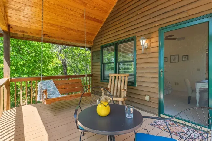 Covered porch space with comfortable seating — ideal for slow mornings or shaded afternoon breaks.