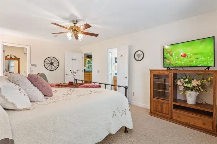 Main-level primary bedroom with king bed and private TV — comfortable and convenient.