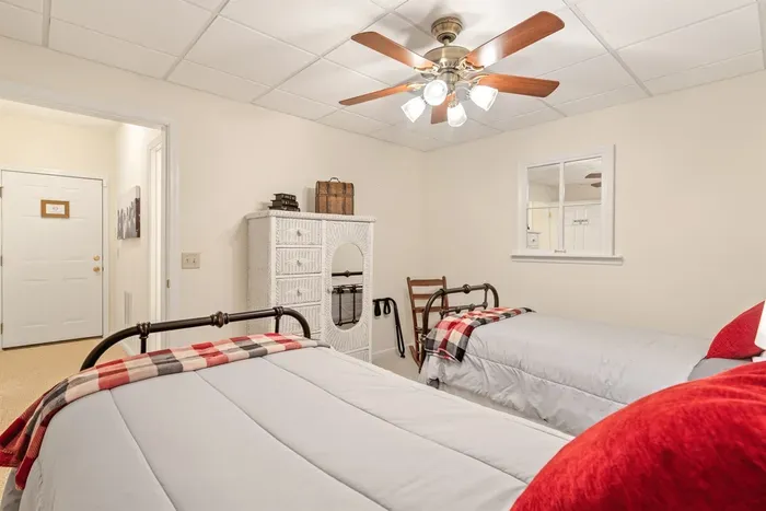 Downstairs bedroom with two twin beds — perfect for kids, teens, or single guests.
