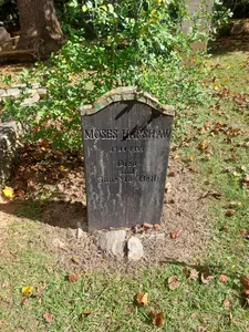 Wooden grave marker for Moses Harshaw beneath the trees at Old Clarkesville Cemetery in Clarkesville, Georgia.