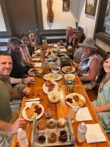 Food tour participants sharing a meal at Bodensee during a Helen & Back Food Tour in Helen, Georgia.