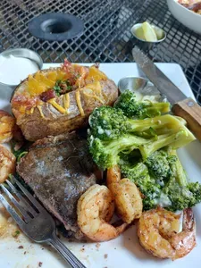 Steak and shrimp with broccoli and a loaded baked potato at Nacoochee Grill in Helen
