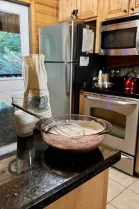 Nora Mill pancake mix, batter, and a whisk ready for breakfast in the kitchen at Freedom Finder