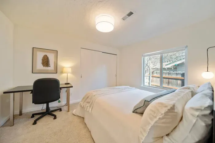 Back bedroom with queen bed. Inside the closet, you'll find the second rollaway twin bed if needed.