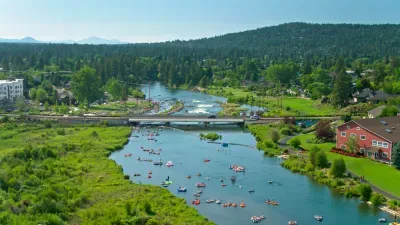 Deschutes River across the street with float-friendly access, bridge views, and forested hills