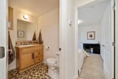 Full bathroom that has a vanity with space to put your belongings. It includes towels, soaps, hairdryer, paper goods.
