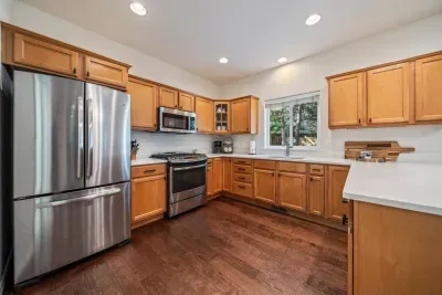 Fully-stocked kitchen with new quartz countertops and bar seating for 4