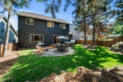 Quiet and private wooded backyard with hot tub, firepit and dining set