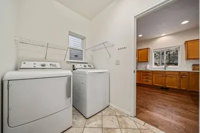 Laundry room with free washer/dryer, ironing board and iron, and large pantry