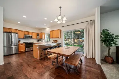 Open concept dining and kitchen, both open to living room